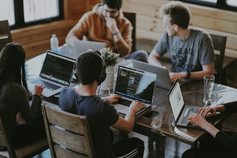 Colleagues working together around a laptop